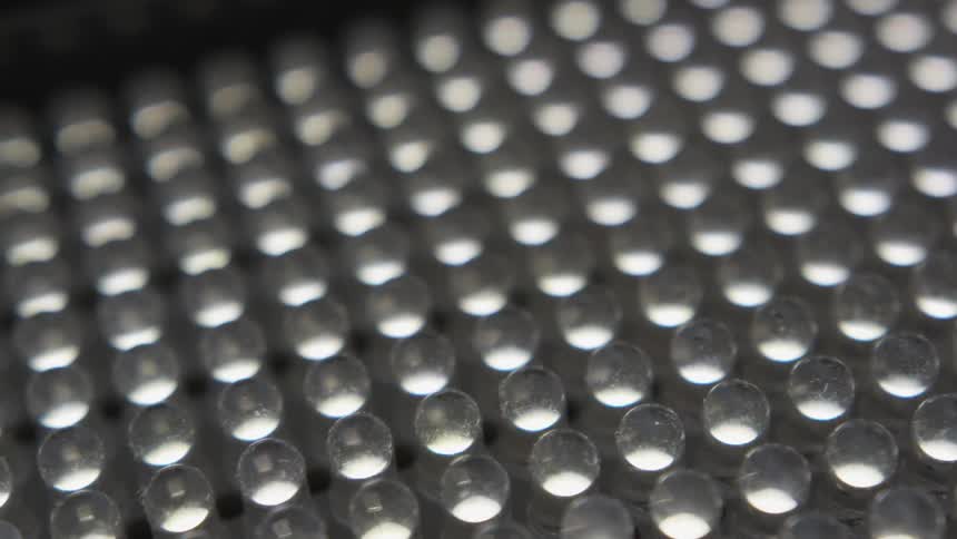 The small beads sit in rows on the platform