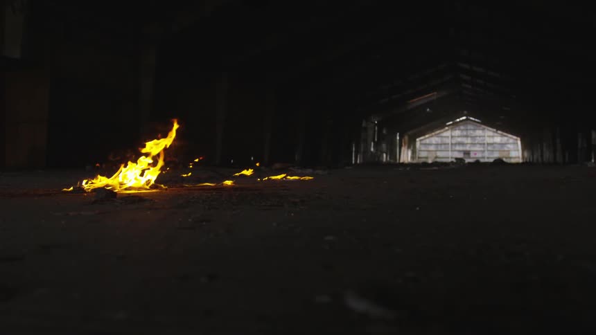 A fire burns inside an empty building