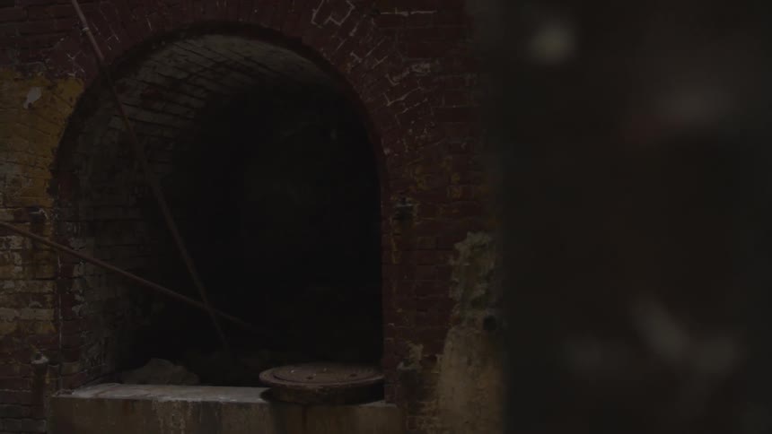The entrance of a dark dreary tunnel