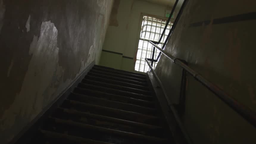 Stairs lead up a staircase in a building