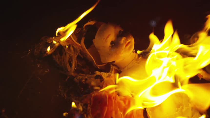 A baby doll burns in a fire