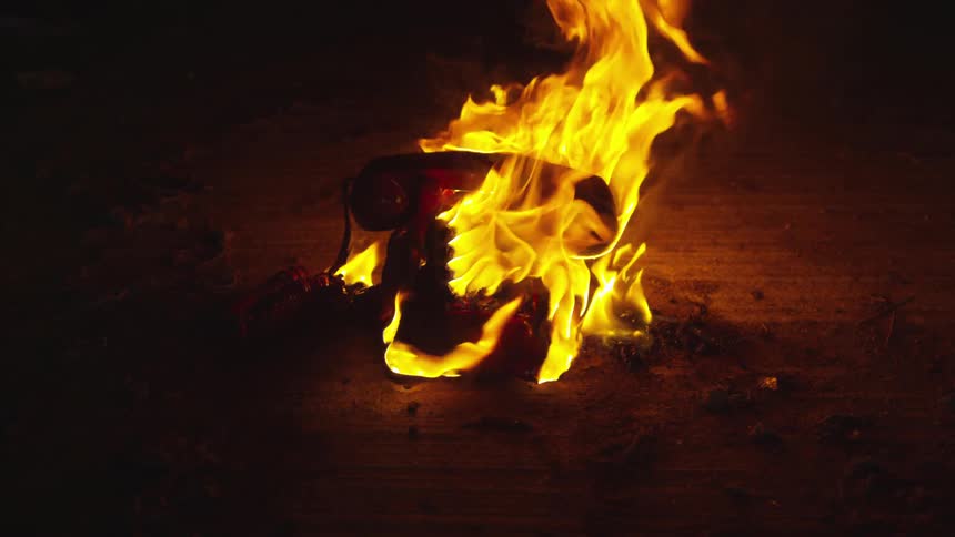 Old telephone burns at dusk