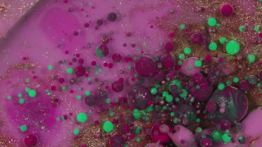 An abstract piece is displayed and is pink, purple, and green