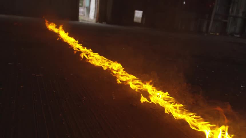 A line of fire burning on the ground