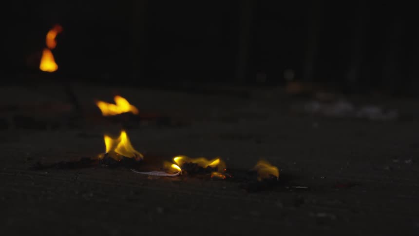 The debris on the ground is on fire