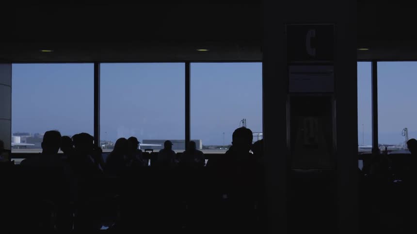 People waiting at an terminal in airport in the dark