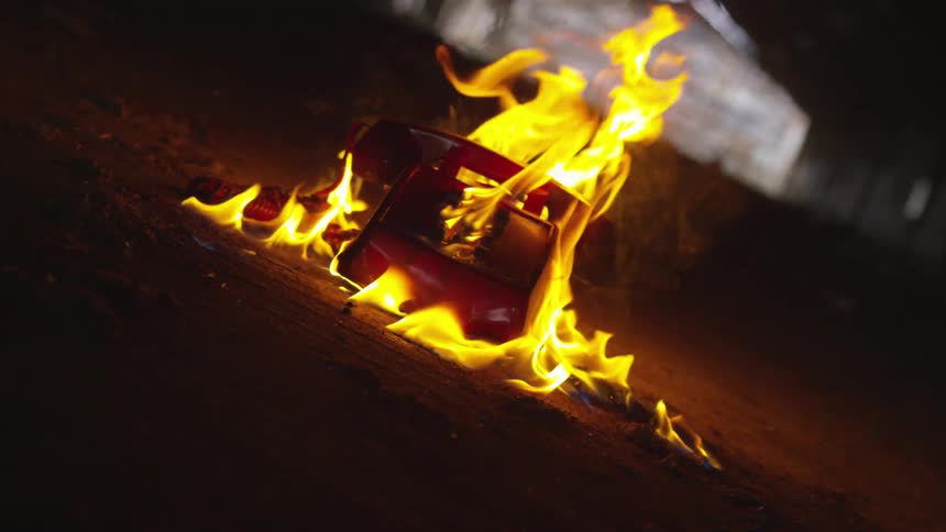 Red corded phone engulfed in flames