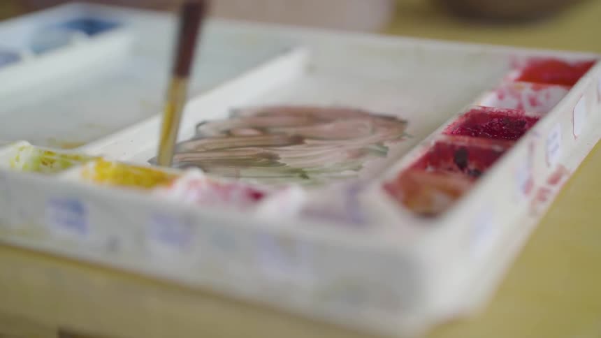 A person is mixing some paint