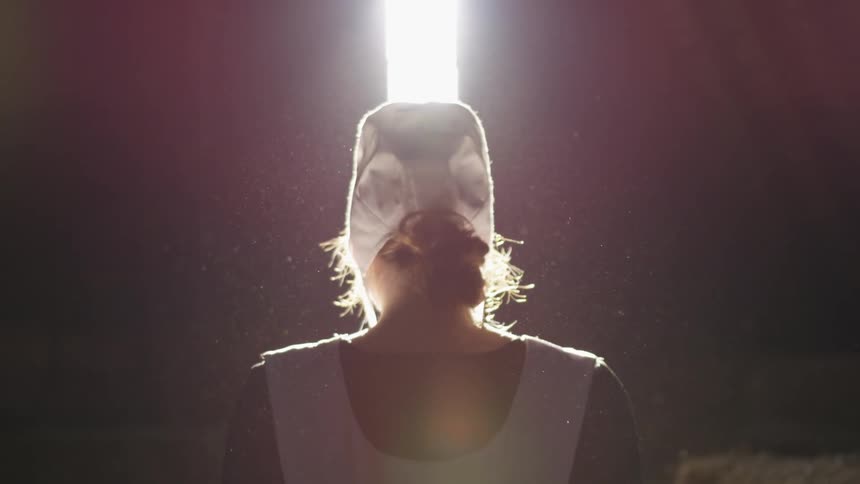 A woman walks towards the door to go outside