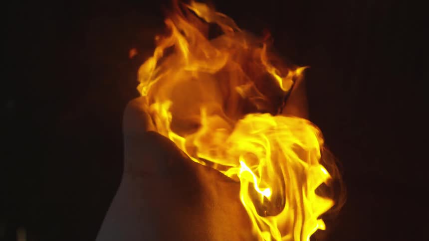 Fire totally engulfs an object in the darkness