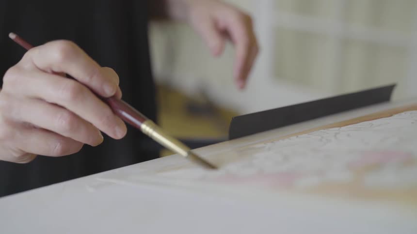 A person using a paint brush