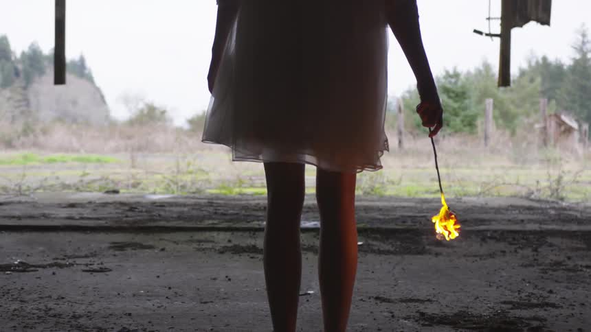 A girl holding a burning rose