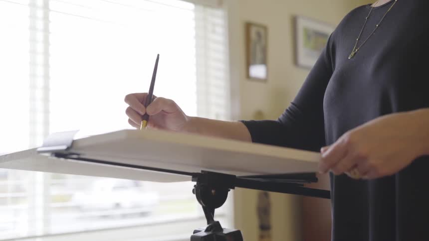An artist paints on a canvas