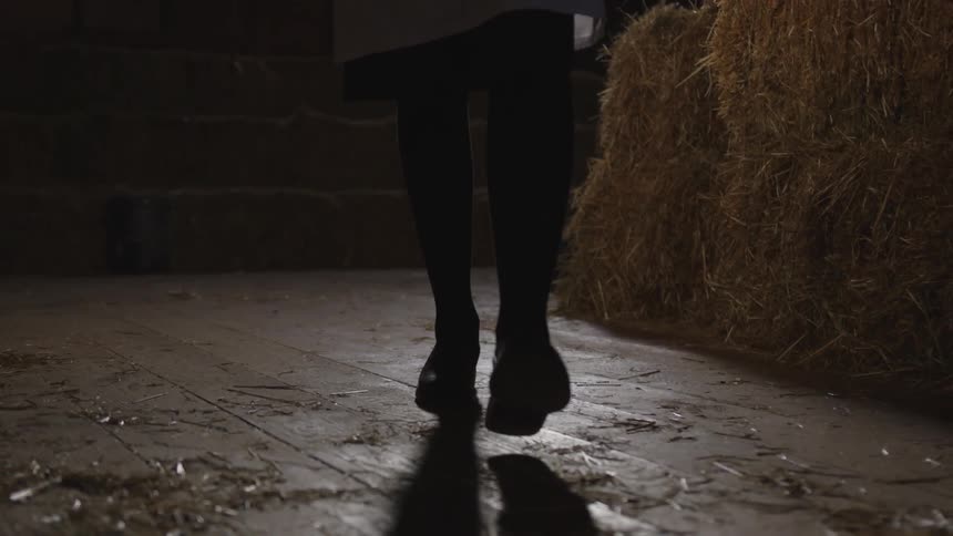 A woman walks through the dark room