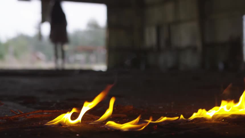 A person stands by a line of fire