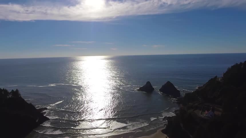 The sun is shining on the rocky shore