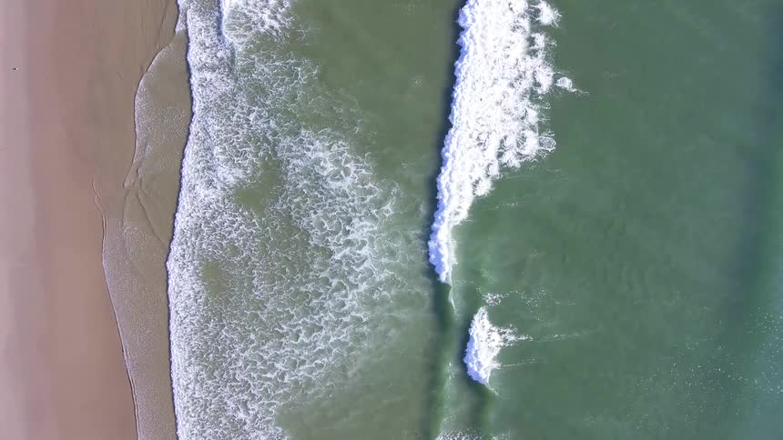 Ocean waves come to a sandy shore