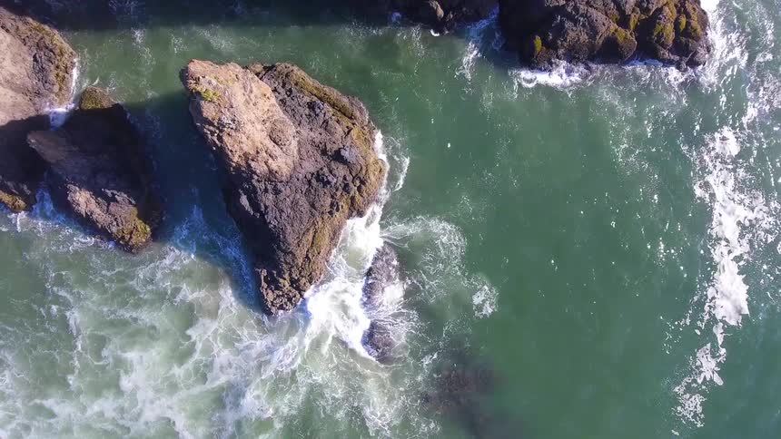 Waves are crashing by the rocks