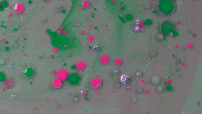 Colorful bubbles move in a circle as if in spinning liquid