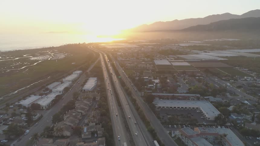 Sun rises over a city and a body of water