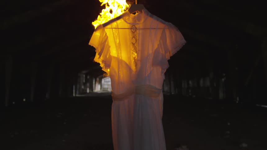 A dress is set on fire in a room