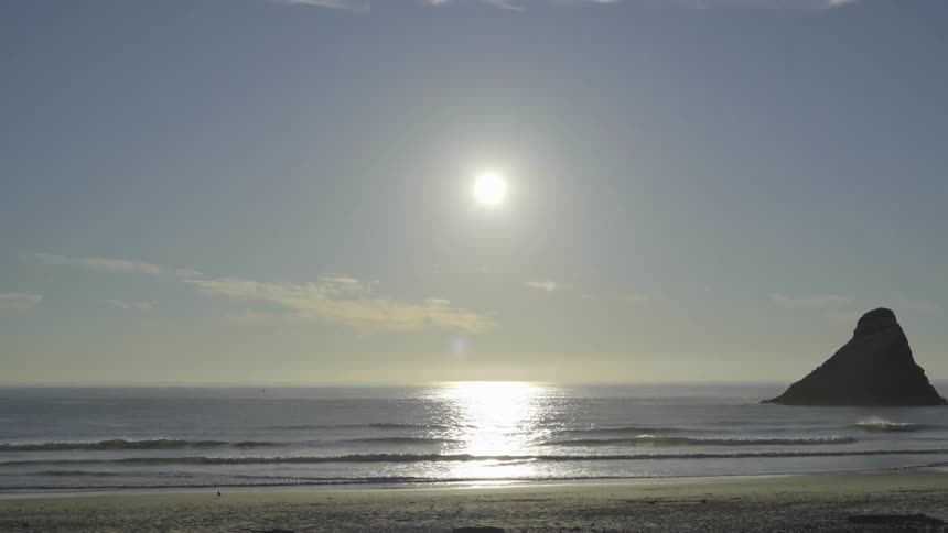 The sun is setting over the beach