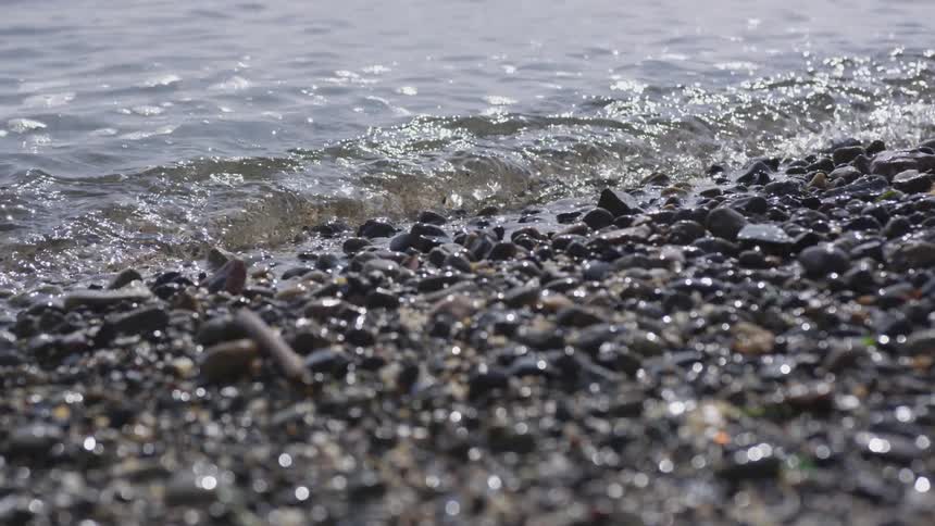 Water flowing on a rocky beach