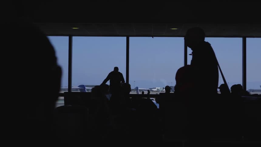 People wait in an airport terminal