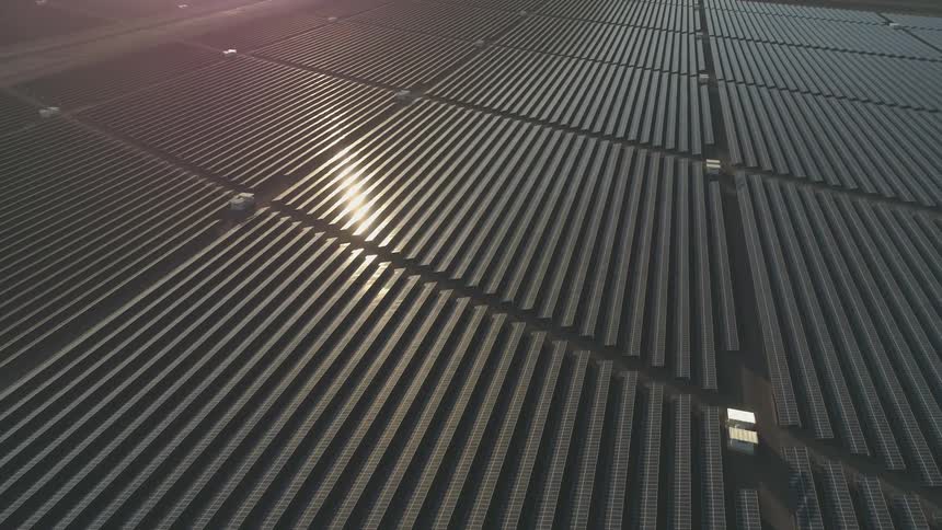 Sunlight shines on rows of solar panels