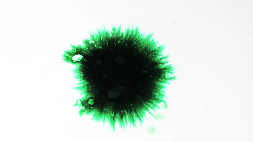 Black ink spot bursting and expanding with green edges