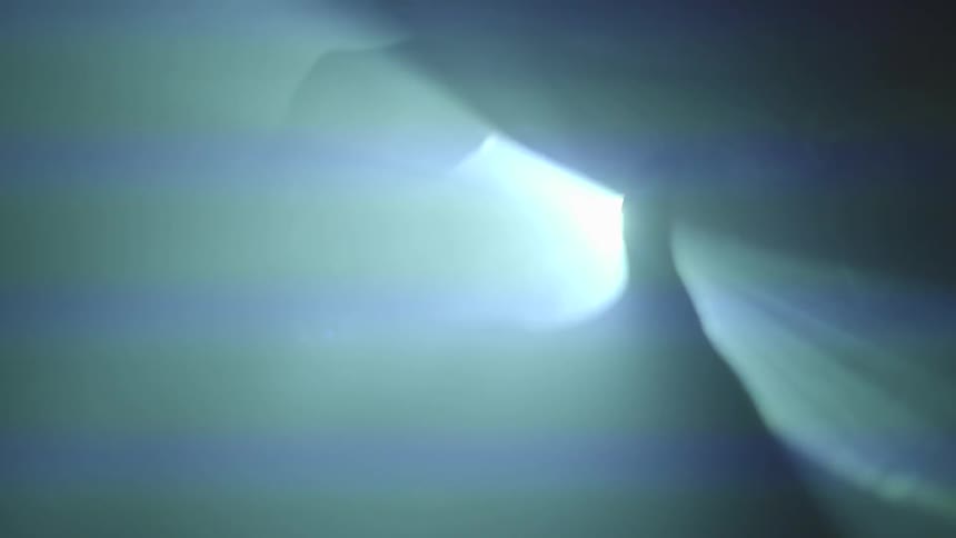 People wave their hands in front of the projector light