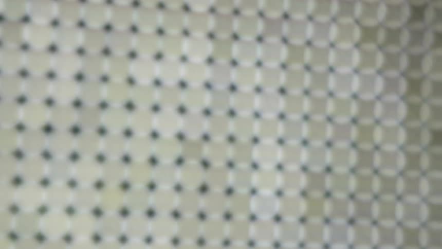 Square pattern design in beige with black dots on corner