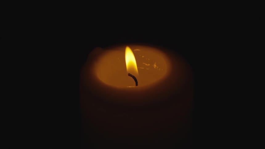The candle is lit in the dark