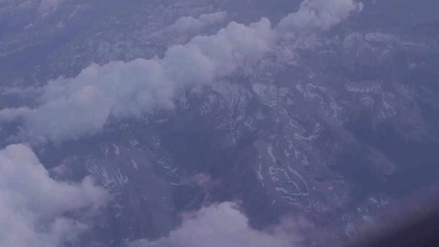 The plane is flying high over the clouds