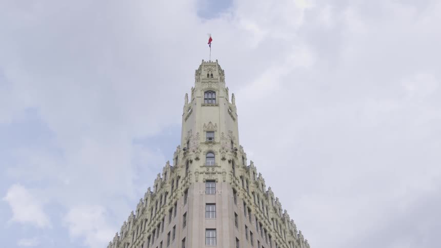 A regal building with a flag on top