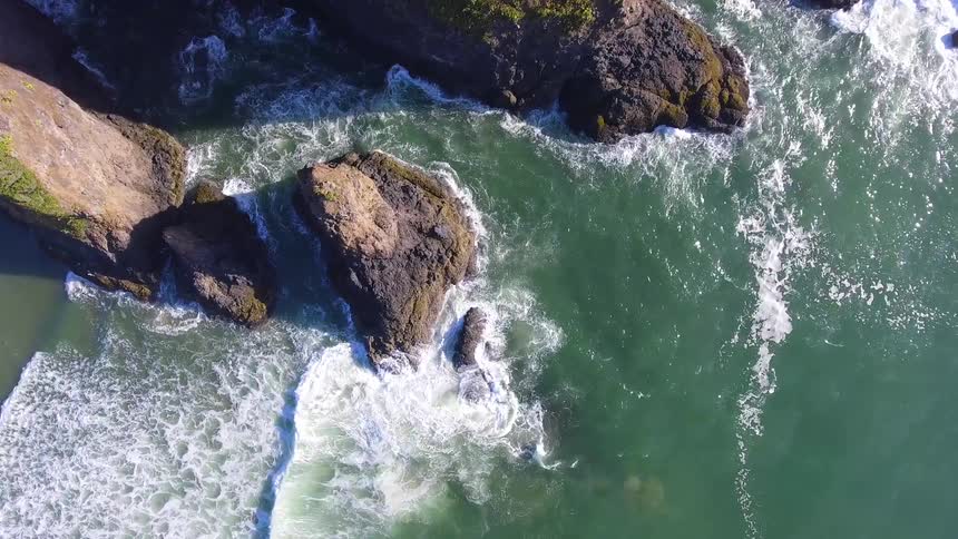Ocean waves crash into a rocky shore