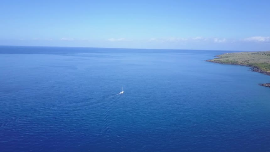 Bright blue ocean waters with a sailboat
