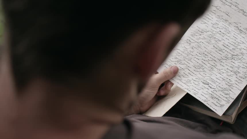 A man reading a letter