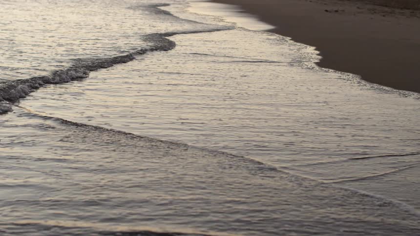 Waves hit the shore of a beach