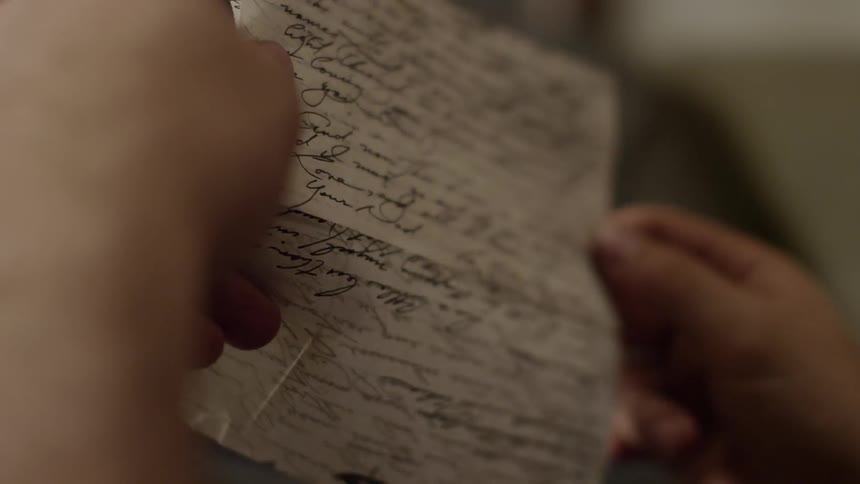 A person reads a handwritten letter
