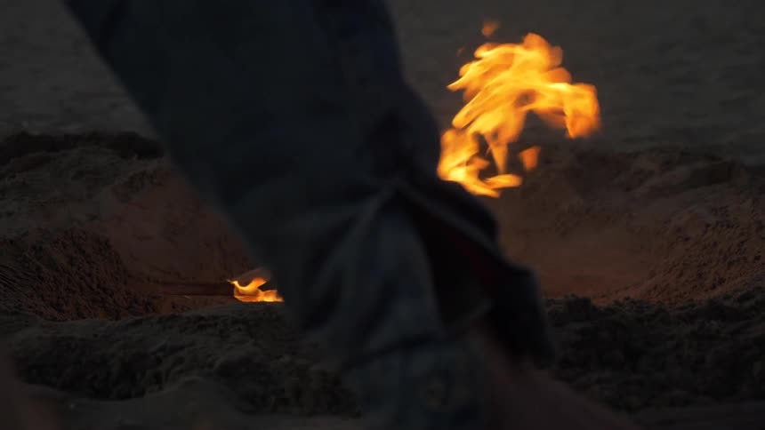 Man Building Fire On The Beach