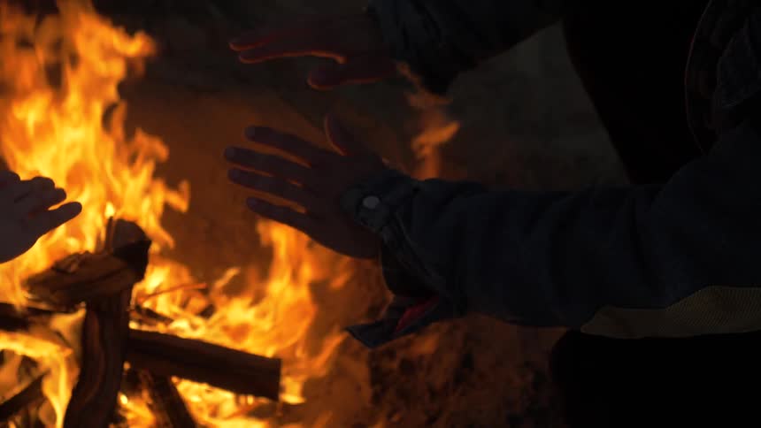 Man Building Fire On The Beach