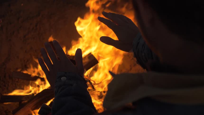 Man Building Fire On The Beach