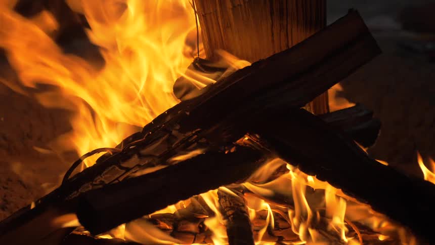Man Building Fire On The Beach