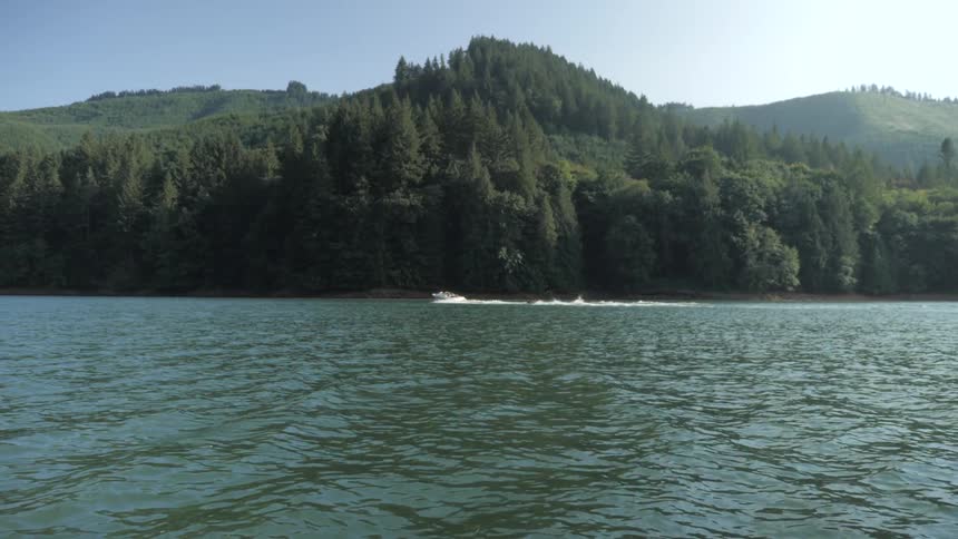 Man Driving Boat Around Lake