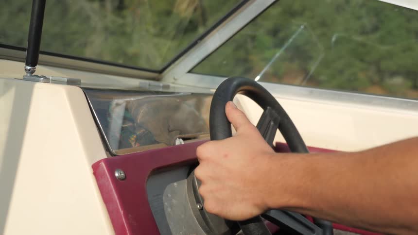 Man Driving Boat Around Lake