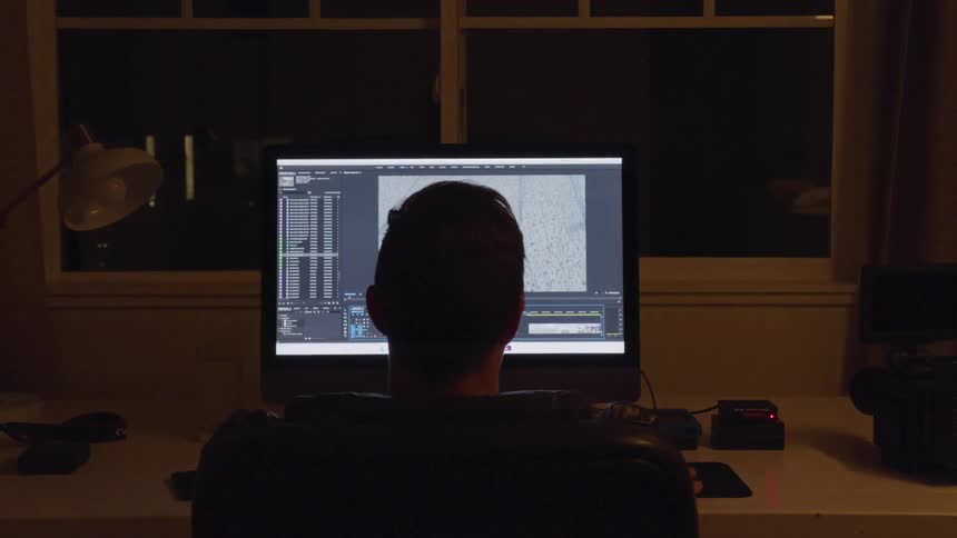 Man Editing Footage At Night