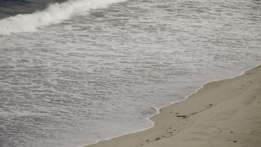 Waves crashing against the beach