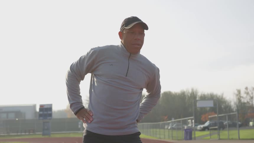 Man Exercising At Stadium
