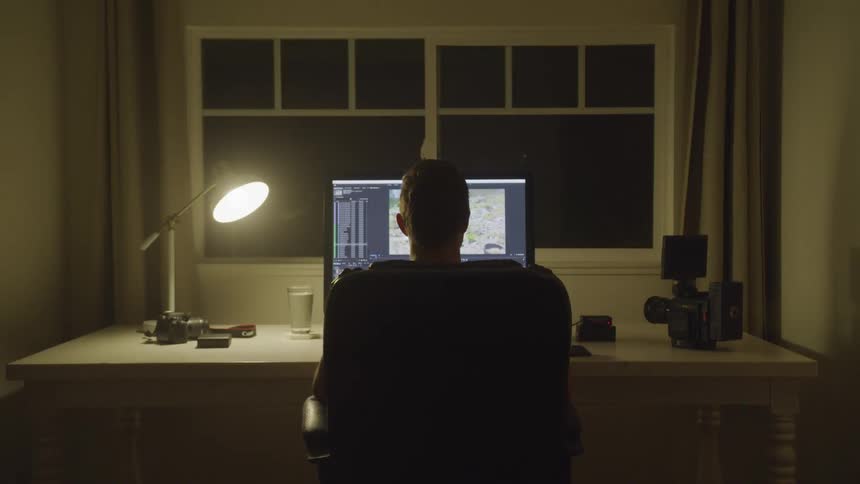 Man Editing Footage At Night